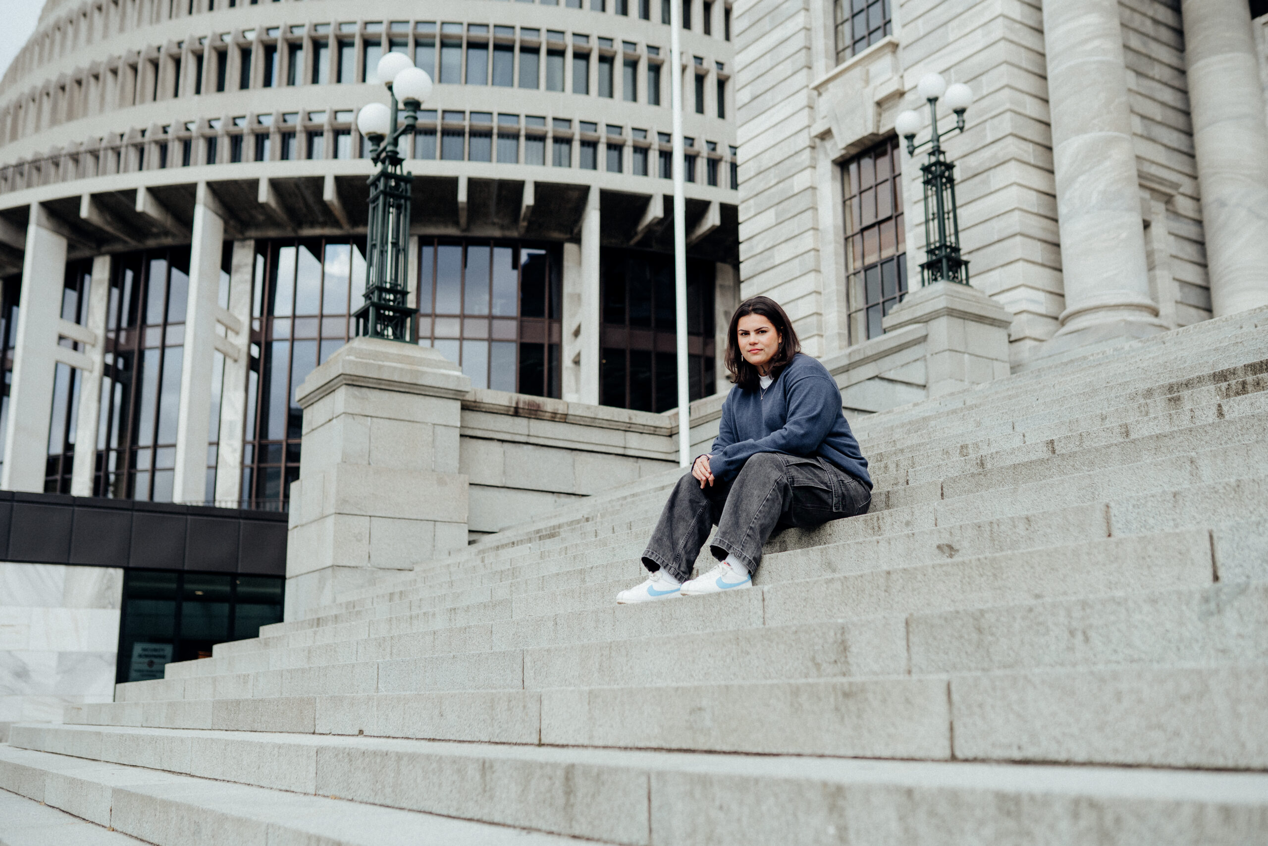 Woman sitting on Parliament steps